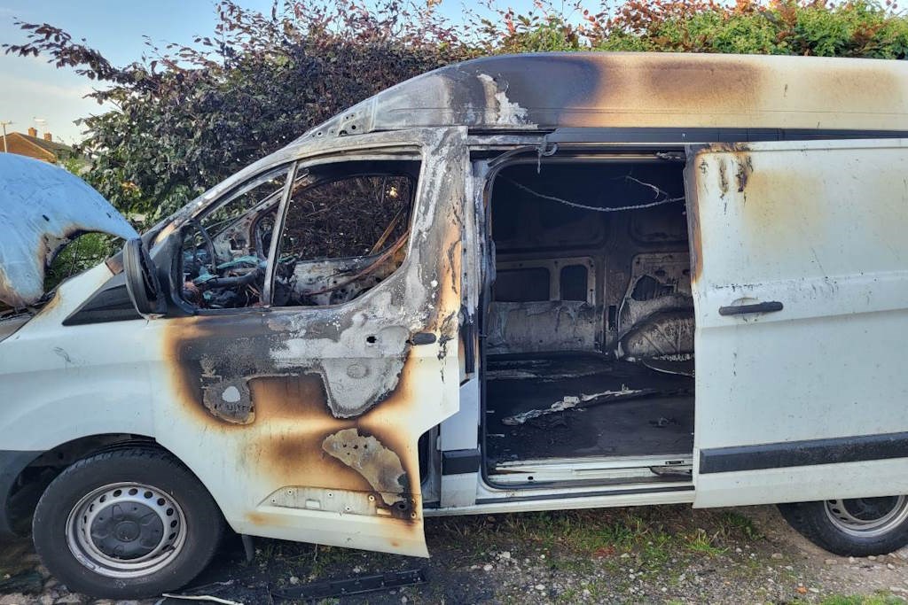 white van burnt out side view