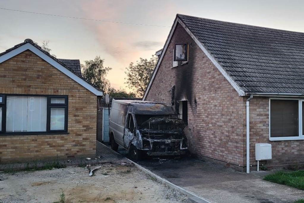 Van on fire between 2 house